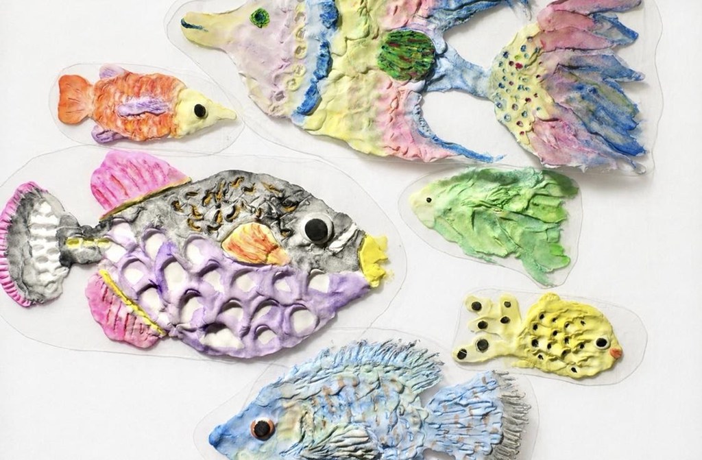 臨床美術のワークショップで制作した、さまざまな模様と色の熱帯魚の作品が並んだ様子